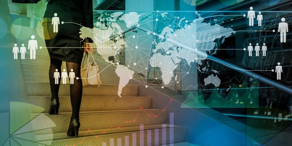 Woman climbing stairs with briefcase in hand with background image of world map